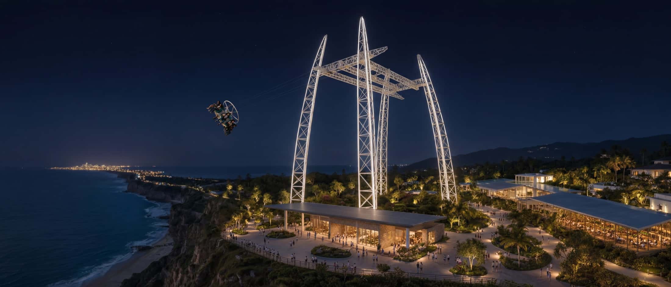The same oceanfront cliff site at night, structures illuminated.